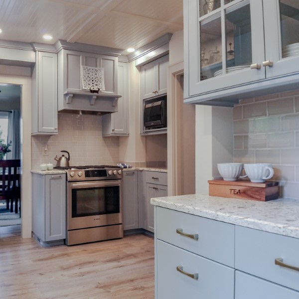 Light gray cabinets surrounding stainless steel slide-in range and subway tile backsplash, Golden Rule Remodeling & Design, Salem Oregon