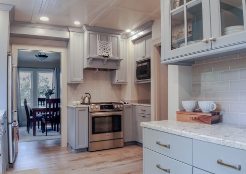 Light gray cabinets surrounding stainless steel slide-in range and subway tile backsplash, Golden Rule Remodeling & Design, Salem Oregon