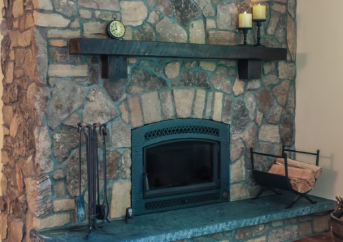 – Stacked stone fireplace with rustic reclaimed wood mantle and honed slab hearth, fireplace remodel, Golden Rule Remodeling & Design Silverton Oregon